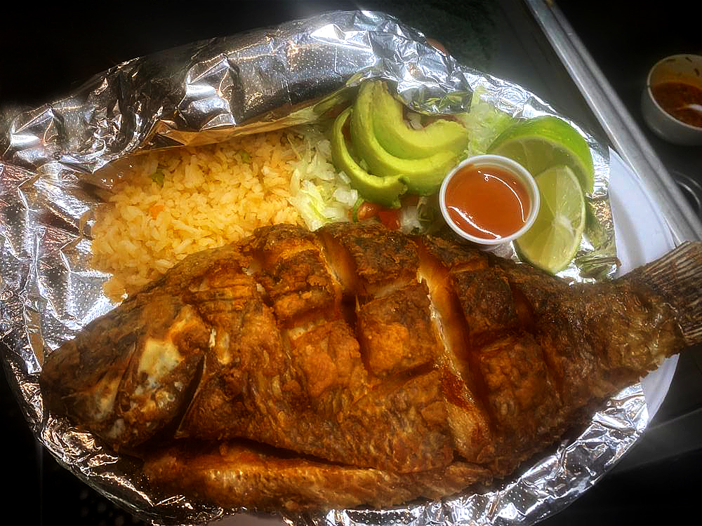 La Oveja Negra Mojarra Frita is a favorite fish dish eaten across Mexico, Colombia, and the Caribbean coast. It consists of a whole tilapia fish cleaned, scored, deep-fried, and sometimes flavored with citrus.